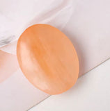 Orange selenite palm stone