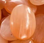 Red selenite palm stone