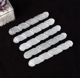 5 white gypsum wands next to each other with smooth and silky finnish.