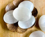 Oval shape selenite palm stone