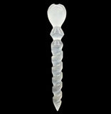 A clear crystal wand with a heart-shaped top against a black background.