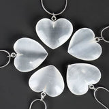 A collection of heart-shaped pendants with a smooth, polished finish.