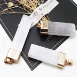 Three rectangular white crystal necklace with ribbed gold caps.