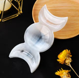 A handcrafted crystal bowl with a triple moon design.