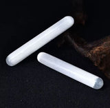 Two white rods with polished surfaces and rounded edges.