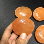 Orange selenite palmstone